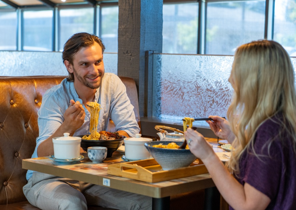 A couple sharing a meal by the window at Ji Bei Chuan