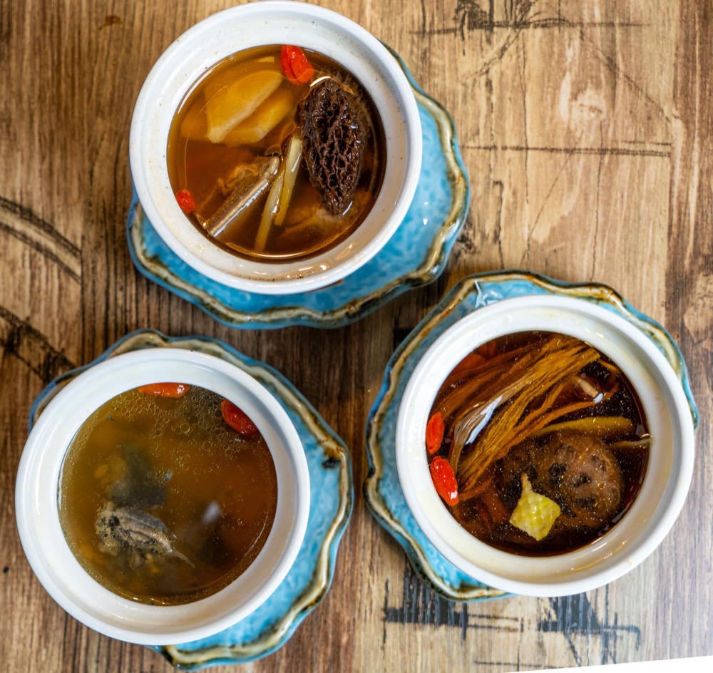 Three slow-simmered soups in white ceramic pots