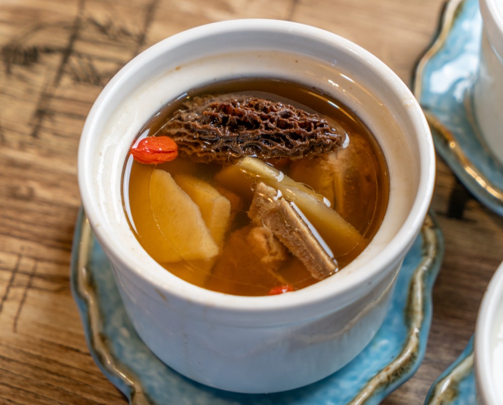 Morel mushroom soup in a ceramic pot